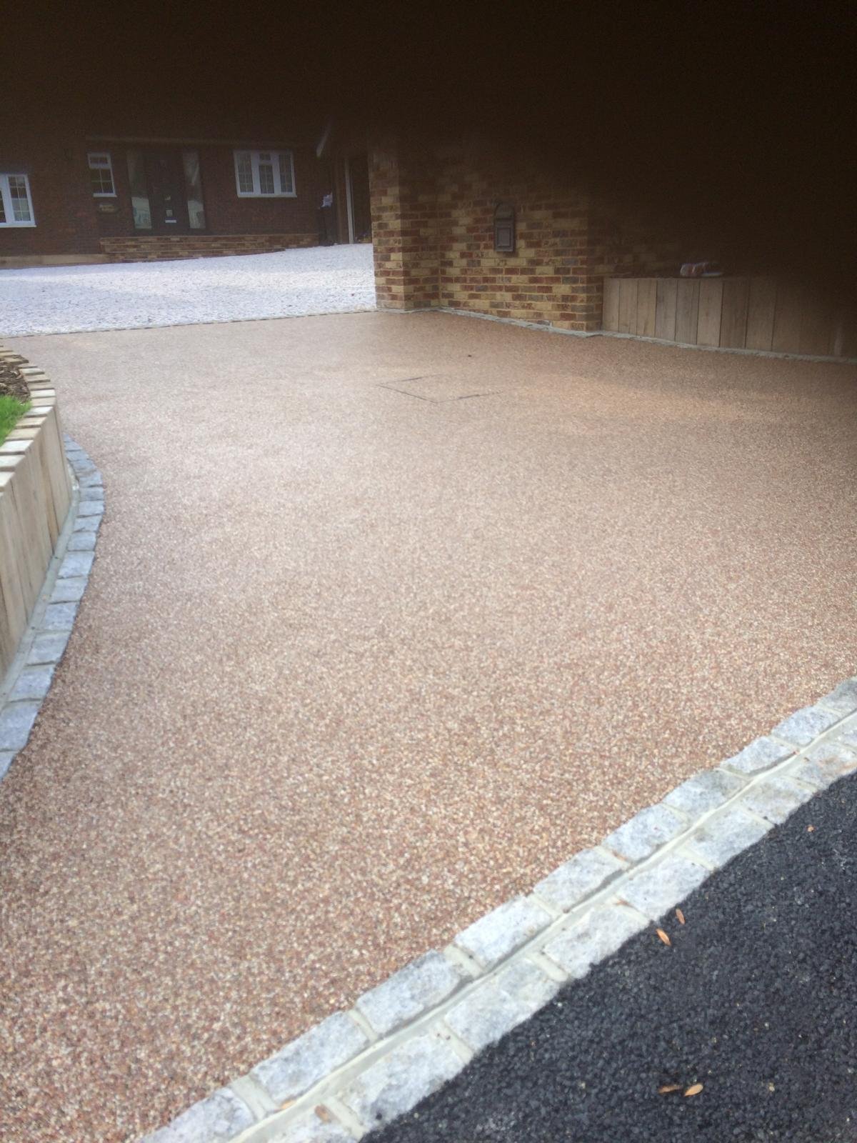 Golden aggregate driveway with a curved stone border